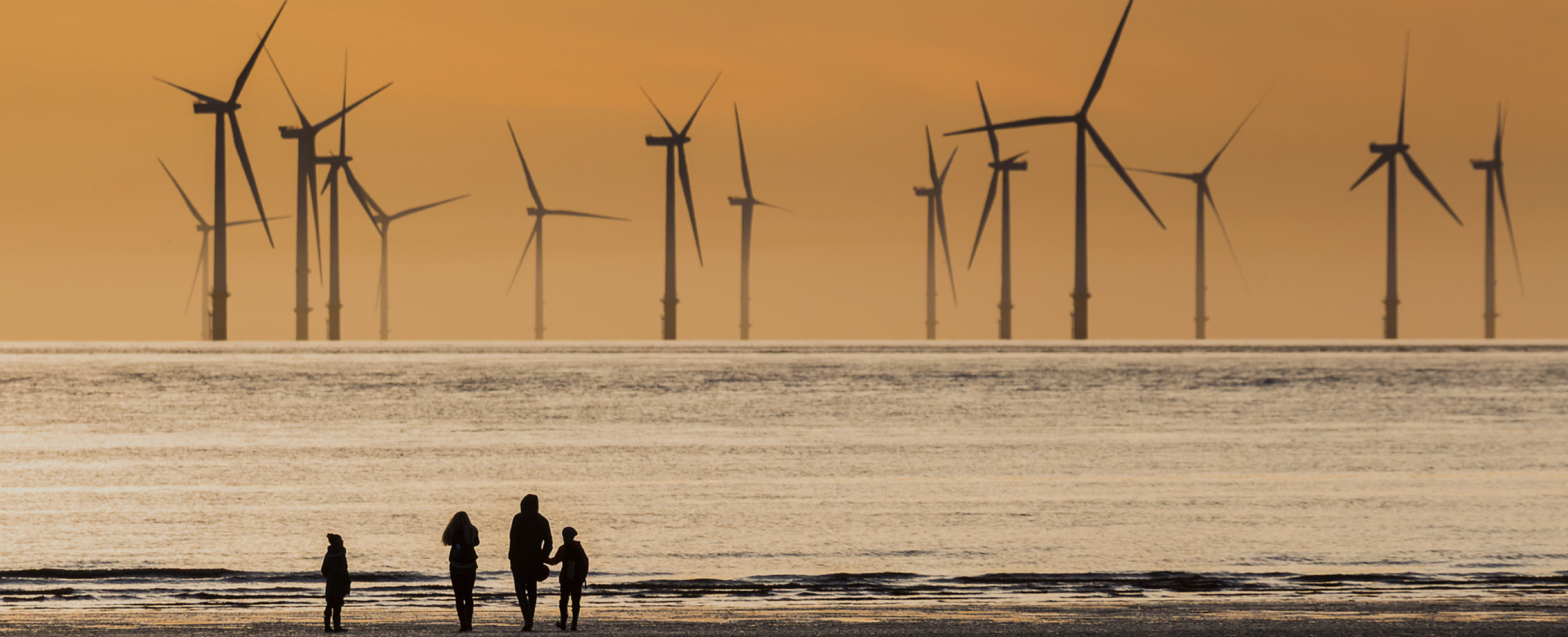 Offshore wind turbine viewed from a beach